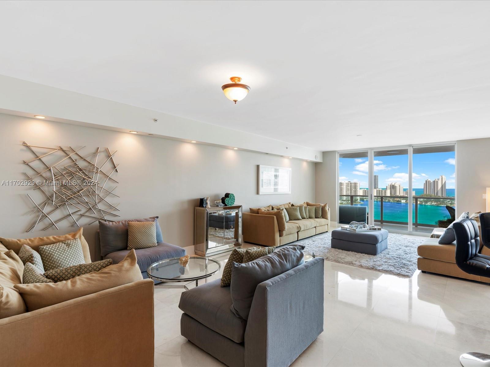 Spectacular 3-bedroom, 3.5-bathroom + den condo in Peninsula II, Aventura, boasting breathtaking east and west water views from the 23rd floor. This 3,069 sqft residence features 2 spacious balconies overlooking the Intracoastal, Sunny Isles skyline, and city lights. Inside, enjoy a generous layout with a den, full-size laundry room, and modern finishes. Peninsula II offers unparalleled amenities: 24-hour concierge, valet, and security, 2 state-of-the-art fitness centers, daily classes, 3 tennis courts, basketball court, playground, splash pad, pools, jacuzzis, BBQ cabanas, dog park, social and business rooms, and a private café for breakfast and lunch. Available for immediate occupancy!