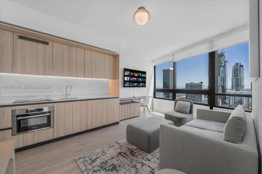 Wake up to panoramic views of the Miami skyline and Biscayne Bay from this fully furnished one-bedroom residence at District 225. Bright and inviting, the residence features expansive windows that frame spectacular city and water views while filling the space with natural light.

Delivered turnkey, the residence showcases contemporary finishes, custom Italian cabinetry, premium appliances, built-out closets, smart-home technology, and a full-size washer and dryer, offering the perfect balance of comfort, style, and investment potential.

District 225 is one of Miami’s newest residential towers designed with hosting in mind and participates in Airbnb’s Resident Hosting Program, offering owners the flexibility to host short-term rentals while benefiting from building guidelines and platform integration. This makes the property an exceptional opportunity for investors seeking strong rental income.

Residents and guests enjoy over 25,000 square feet of resort-style amenities including a rooftop pool deck, fitness center, indoor basketball and racquetball courts, rock-climbing wall, golf simulator, spa with sauna and steam rooms, co-working spaces, BBQ areas, social lounges, café service, concierge, valet, and 24-hour security.

Located in the heart of Downtown Miami, just minutes from Brickell, Miami Worldcenter, Brightline station, Kaseya Center, and Miami Beach.