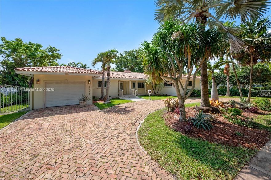 Located on one of the most desirable streets, this beautifully maintained home offers 2,415 square feet of comfortable living space on an expansive 11,382 sq. ft. lot. The property features four generously sized bedrooms and three full bathrooms, including a spacious primary suite with a private en-suite bath and ample closet space in every room. The inviting living room boasts a charming wood-burning fireplace, while rich wood and porcelain flooring flow seamlessly throughout the home. A bright and open-concept kitchen connects to the formal dining area and a cozy breakfast nook, all overlooking a large, wood-beam covered terrace—perfect for outdoor dining and entertaining. The terrace includes a built-in barbecue and opens to a lush, grassy backyard with plenty of room for a pool.