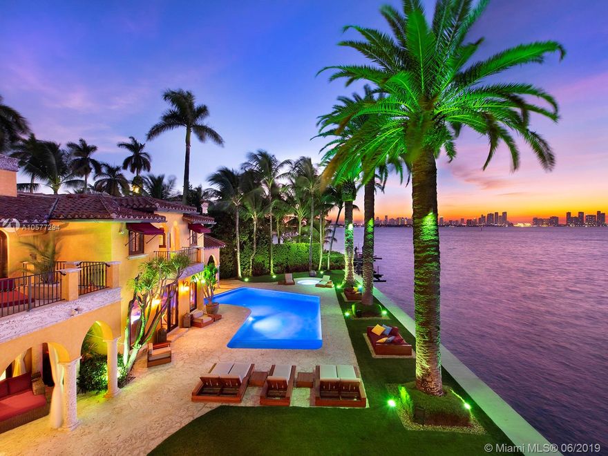 Enrique Iglesias former home Villa Jasmine, sits on the SW tip of prestigious gated community Sunset Island 1. Exotic waterfront estate offers direct Miami skyline & Biscayne Bay views. Impressive granite driveway lined by majestic Royal Palms, leading to a luxurious 7,622 SF home. Main house has an interior courtyard & fountain, soaring arched windows which provides indoor/outdoor Florida lifestyle. Spacious living areas, formal dining, large chef’s kitchen and unique onyx wet bar. Guesthouse w/ rooftop/Jacuzzi and 150’ screen cinema. Large backyard w/ pool, gazebo & summer kitchen. 22,093 SF Lot w/ dock, w/ 150 ft of prime water-frontage, 22,000 lb boatlift & 3-car garage. A true luxury estate designed to enjoy the dramatic sunsets and views of the ever-growing dazzling Miami skyline.