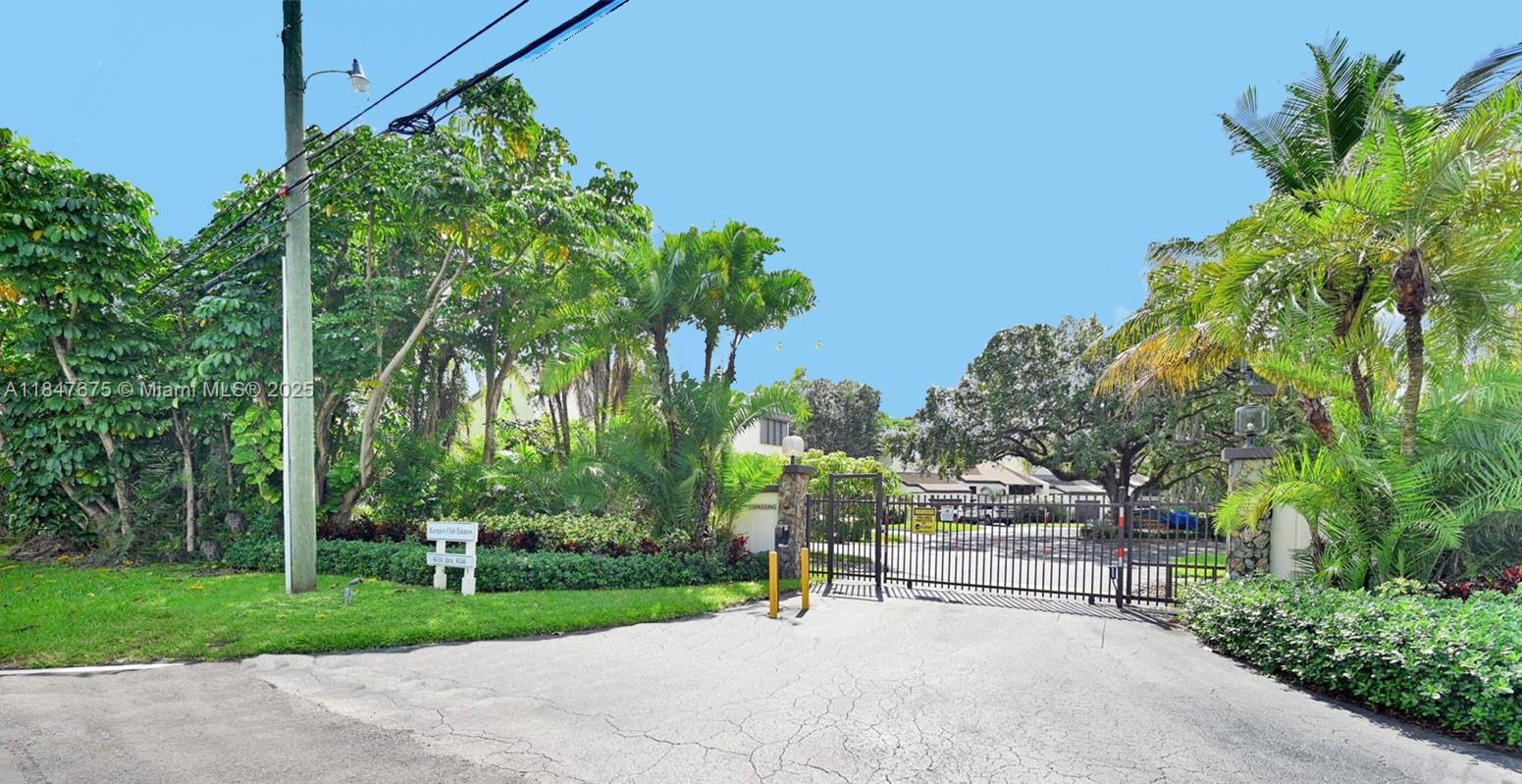 Escape to your own Private Paradise in this Updated Contemporary 4 bedroom, 3 bath Oasis, nestled in an Exclusive Gated Enclave of just 16 homes. Designed for Tranquility and Connection, this Two-Story Gem blends Upscale Living with Resort-Style Amenities including a Sparkling Community Pool, Tennis Courts, and Meandering Walking Paths shaded by Tropical Greenery. Step inside to find an Expansive Living Space with Soaring Vaulted Ceilings in the Living and Dining Areas, Engineered Wood and Tile Flooring, Impact-Rated Doors and Windows, and Abundant Natural Light that elevates everyday living. Enjoy a Custom Gourmet Kitchen & Wet Bar, Featuring White Wood Cabinetry, Stainless Steel Thermador Appliances, and Sleek Modern Finishes tailored for Stylish Entertaining. See Supplemental Remarks.