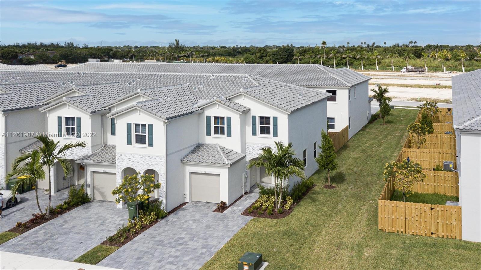 LIKE new CORNER townhome located in the exclusive Homestead community, The Riviera. Stunning 3 bed & 2.5 bath home. The great chef's kitchen features tall & white wooden cabinets & top-of-the-line stainless steel appliances. This WIFI-certified home lets you enjoy having a signal in every corner of the property. RING Doorbell with video included. Completely wired with OPTIC CABLE for maximum high-speed internet. Washer & dryer included. Tank-less water heater. The luxurious resort-style clubhouse will feature a pool, jacuzzi, full gym & play area! Located near the Baptist Hospital, Homestead Air Reserve Base & Turkey Point. Easy access to the turnpike. Very easy to show, call for a private showing today!