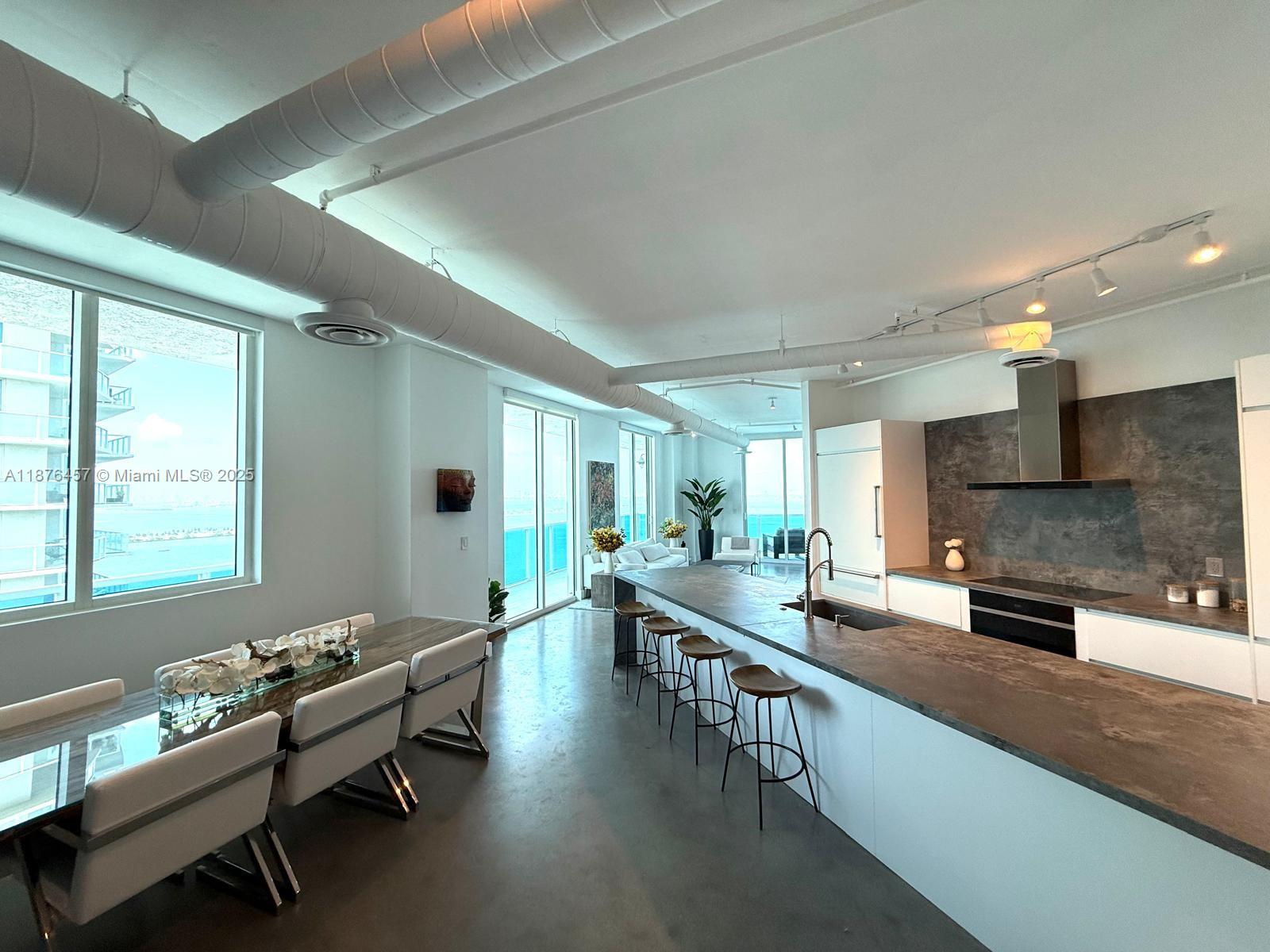 Discover the exquisite Star Lofts Residence 2003, nestled in the vibrant Edgewater neighborhood of Miami. Step onto the impressive wrap-around balcony where nearly 1k SqFt of unobstructed panoramic views of the Biscayne Bay, Atlantic Ocean, and the Miami skyline. Inside, you’ll find a spacious and inviting open floor plan, an oversized kitchen and an expansive main bedroom suite. Its loft-styled design boasts 10-foot ceilings, exposed AC ducts & conduits. Star Lofts is a charming boutique building w/only three units per floor, It is also exceptionally pet-friendly, complete with its very own dog park on the 7th floor. Other amenities that Star Lofts has to offer, including a newly renovated infinity-edge pool, an elegant lobby, a fully equipped gym, and convenient storage and bike rooms