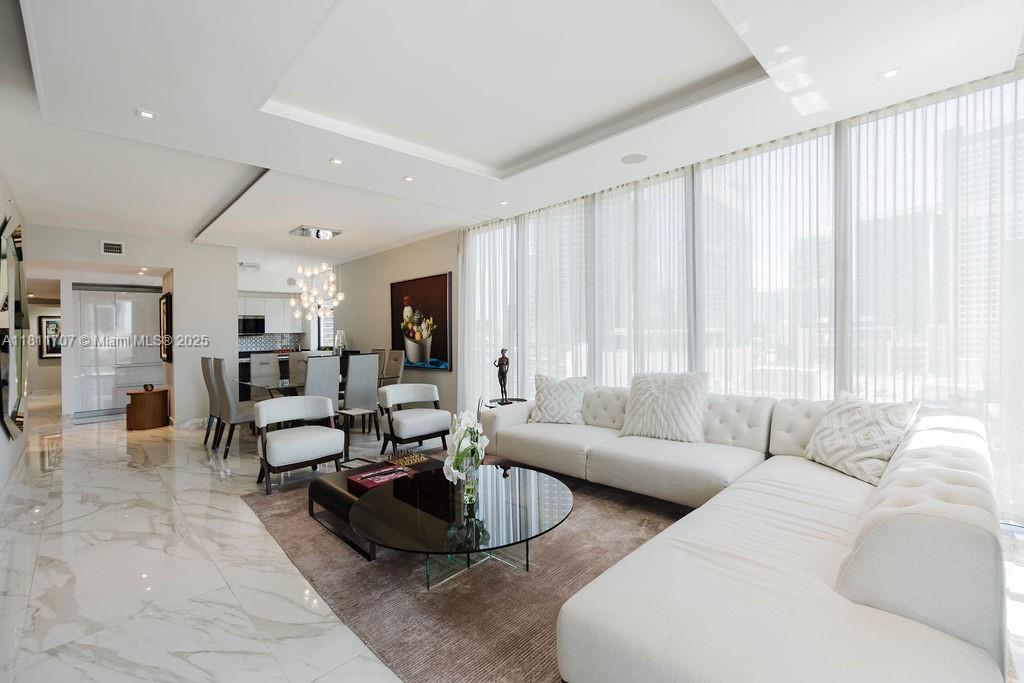 Discover luxury living in this beautifully designer finished corner unit in the heart of Brickell. Enjoy high-end finishes and natural light, with a 2 CAR PRIVATE GARAGE featuring an EV charger and direct elevator access. This spacious home offers 3 bedrooms plus a den. Indulge in resort-style amenities: a Hammam spa, sports courts, plunge pool, cinema, rooftop pool, 50th-floor dining, and a kids' club with bowling. Experience unmatched elegance and convenience.