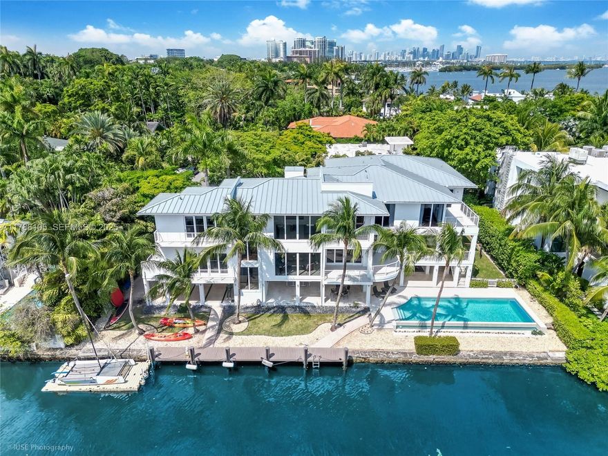 A private tropical oasis—waterfront estate with 150 FT of water frontage in the exclusive gated Four Way Lodge Estates, Coconut Grove. Located in Miami’s most prestigious neighborhood nearby two of the city’s top private schools. An ideal floor plan for modern family living & entertaining with a total of 11,316 SF- feat. 6-beds, 6.5 baths, cabana bath, soaring ceilings, open living spaces and expansive water views. Gourmet kitchen w/ premium appliances, oversized island, & gas range. Covered terrace with summer kitchen, turf play area, outdoor multifunctional area & saltwater infinity pool overlooking private dock with bay access. Double door entrance to huge master suite w/ private library. Balconies in every room. Elevator, generator, impact windows/doors, 2-car garage + 3 carports.