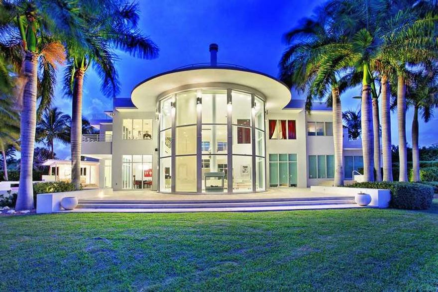 A SHOWCASE, STUNNING CONTEMPORARY VILLA ON SE POINT LOT FRONTING INTRACOSTAL WATERWAY. MESMERIZING 22-FOOT GLASS WALLS OFFER WATER VIEWS FROM 3 LEVELS & INCREDIBLE NATURAL LIGHT. WELL-CONSTRUCTED WITH CONCRETE & STEEL, FEATURES INCLUDE POLISHED LIMESTONE  FLOORS, MEDIA ROOM, MOTORIZED CURTAINS, SMART HOME TECHNOLOGY,  ELEVATOR, GENERATOR, OFFICE, 3,500 SQ. FT. OF TERRACES/BALCONIES & GORGEOUS POGGENPOHL KITCHEN.  PARADISICAL POOL AREA FRAMED BY 267-FEET OF WATER, NO-WAKE ZONE, NO BRIDGES TO BAY.