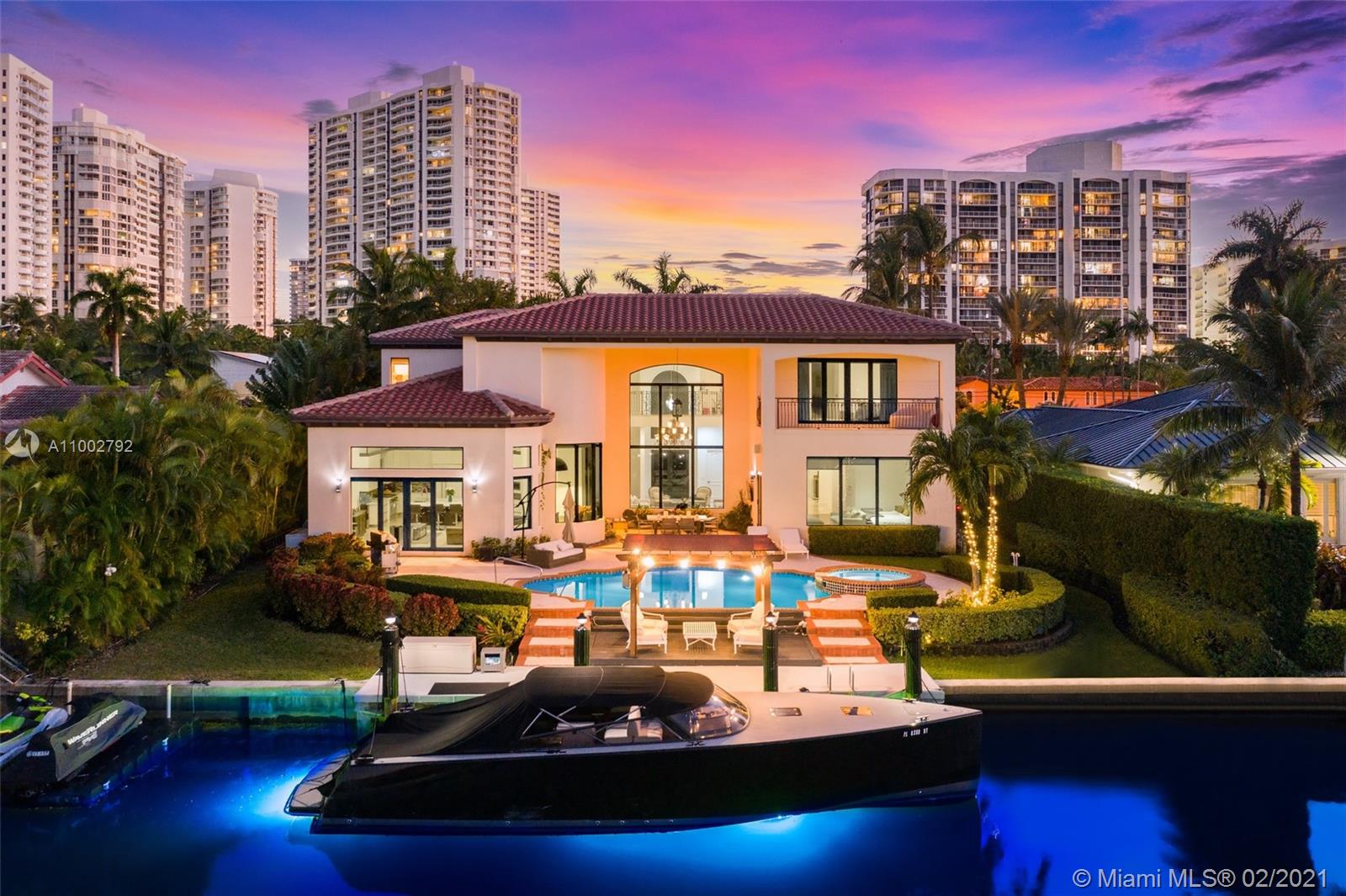 Two story waterfront residence with 90 ft. of deep water frontage. This home boasts 6 bedrooms, 6.5 bathrooms of the finest quality finishes throughout all 7,000+ sq. ft. With two master suites, soaring ceilings, Saturnia marble and wood flooring, extensive landscaping, large terrace overlooking the water, heated pool and spa and deeded boat dockage, you will be proud to call this your home. Gourmet kitchen with Brazilian granite countertops and handmade wood cabinetry, top-of-the-line Wolf and Sub-Zero appliances. First floor master features a water closet, his/hers walk-in closets, and more.