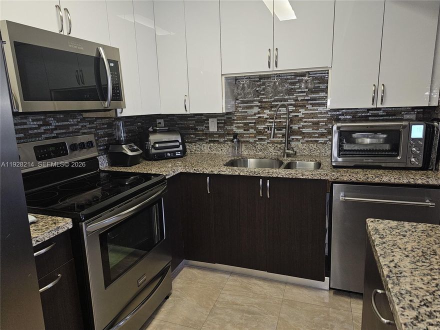 Welcome to this inviting garden corner residence, a peaceful retreat designed for comfort and ease. This well-appointed home features two spacious bedrooms and two bathrooms, thoughtfully positioned on opposite sides to enhance privacy.

The updated kitchen offers a pleasant cooking experience, featuring newer stainless-steel appliances and clean, modern cabinetry. Ideally located in North Miami, just moments from Aventura, the property provides convenient access to I-95 and the Palmetto Expressway, allowing for easy travel to both downtown Miami and Fort Lauderdale.

The home includes one assigned parking space, along with ample guest parking. Residents can also enjoy the community’s sparkling pool and relaxed South Florida atmosphere.

Please note: the community requires a minimum 5% down payment. A capital contribution is required by Quatraine Homeowners Association and payable by the buyer. All information should be verified with the management company. Living room chandelier and all ceiling fans are excluded from the sale.