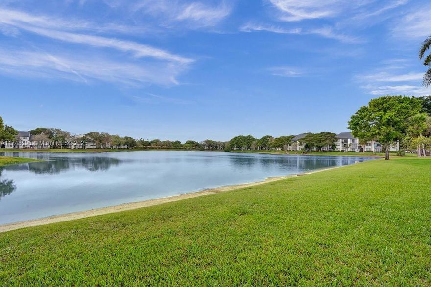 Endless water views surround you in this stunning unit, where every window frames a picturesque lake vista! This bright, airy home is filled with natural light. Located in the highly sought-after Banyan Springs, this condo boasts light wood flooring throughout, paired with soft neutral paint, creating a fresh and immaculate feel. The kitchen features sleek cabinets, granite countertops, plus an eat-in butcher block table where you can savor the breathtaking water views! Relax on the lanai and enjoy the cool view—pure bliss! Meet new neighbors and enjoy an active lifestyle at the fabulous Banyan Springs clubhouse, offering a restaurant, entertainment, a fitness center, two resort-style pools, pickleball and tennis courts, billiards, bocce, and plenty of social clubs!