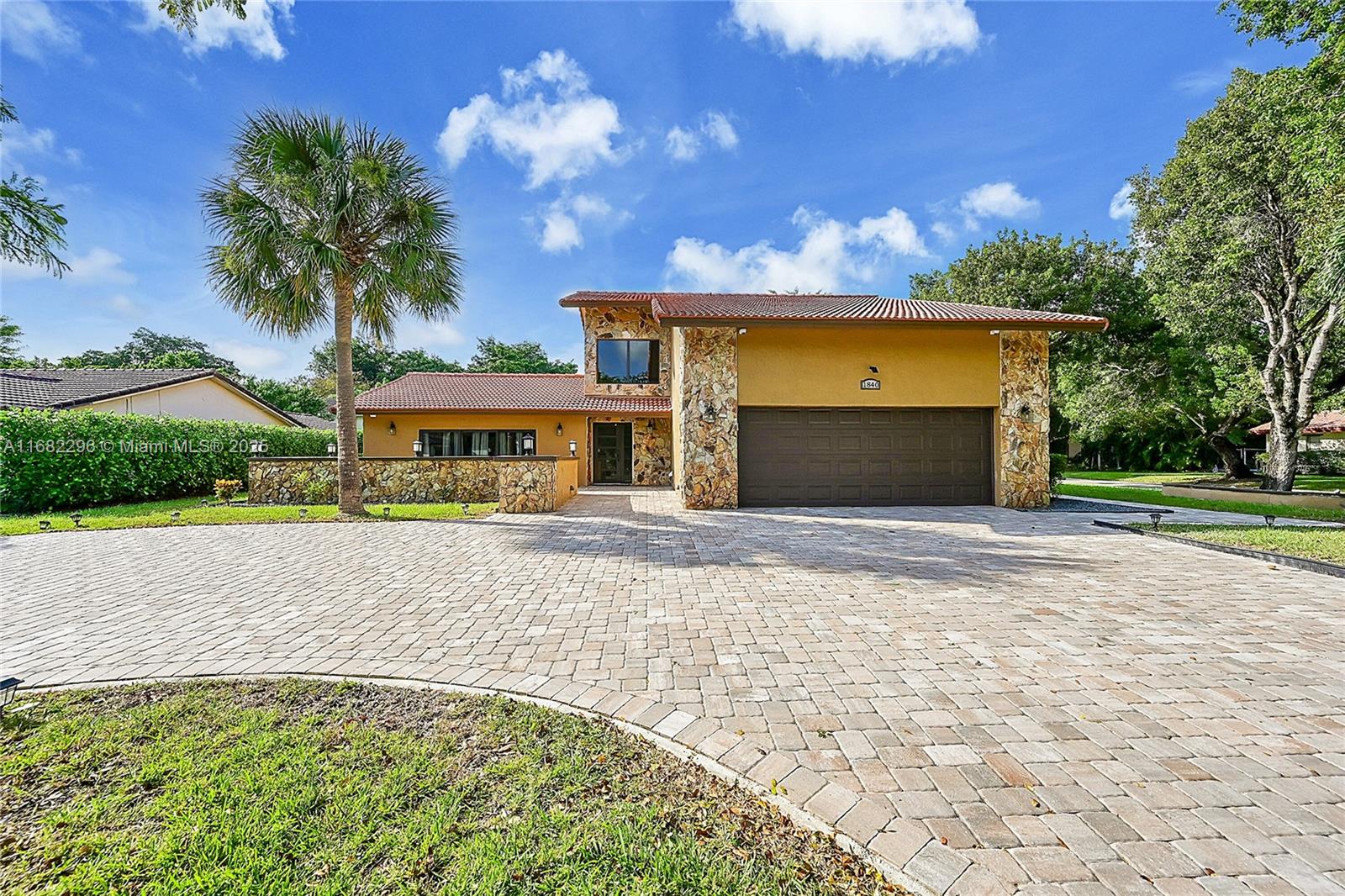 Welcome home! Beautifully updated 5-bedroom, 4-bathroom two-story residence, is a rare family-friendly find in one of the best locations in Coral Springs! This home includes a unique 1-bedroom, 1-bathroom apartment with a separate entrance/KITCHEN/W/D—perfect for guests or income-producing opportunity. Fireplace. Remodeled kitchen tons of cabinetry & SS appliances. Updated bathrooms. New impact windows and doors, newer water heater, water filtration system, & alarm system. Primary suite provides its own balcony. Gorgeous newly paved driveway parks 6+ vehicles. Remodeled garage includes: Lights, floors, cabinets! Located to just about anything you need—ideal for families looking & space, convenience, and modern comforts all in one! Move in READY! Custom built! RARE FIND & A MUST SEE.