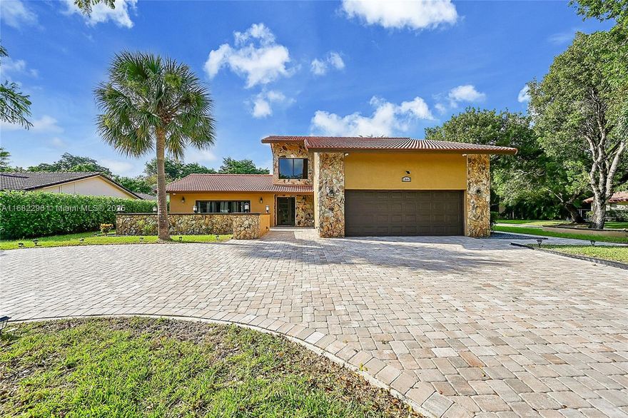 Welcome home! Beautifully updated 5-bedroom, 4-bathroom two-story residence, is a rare family-friendly find in one of the best locations in Coral Springs! This home includes a unique 1-bedroom, 1-bathroom apartment with a separate entrance/KITCHEN/W/D—perfect for guests or income-producing opportunity. Fireplace. Remodeled kitchen tons of cabinetry & SS appliances. Updated bathrooms. New impact windows and doors, newer water heater, water filtration system, & alarm system. Primary suite provides its own balcony. Gorgeous newly paved driveway parks 6+ vehicles. Remodeled garage includes: Lights, floors, cabinets! Located to just about anything you need—ideal for families looking & space, convenience, and modern comforts all in one! Move in READY! Custom built! RARE FIND & A MUST SEE.