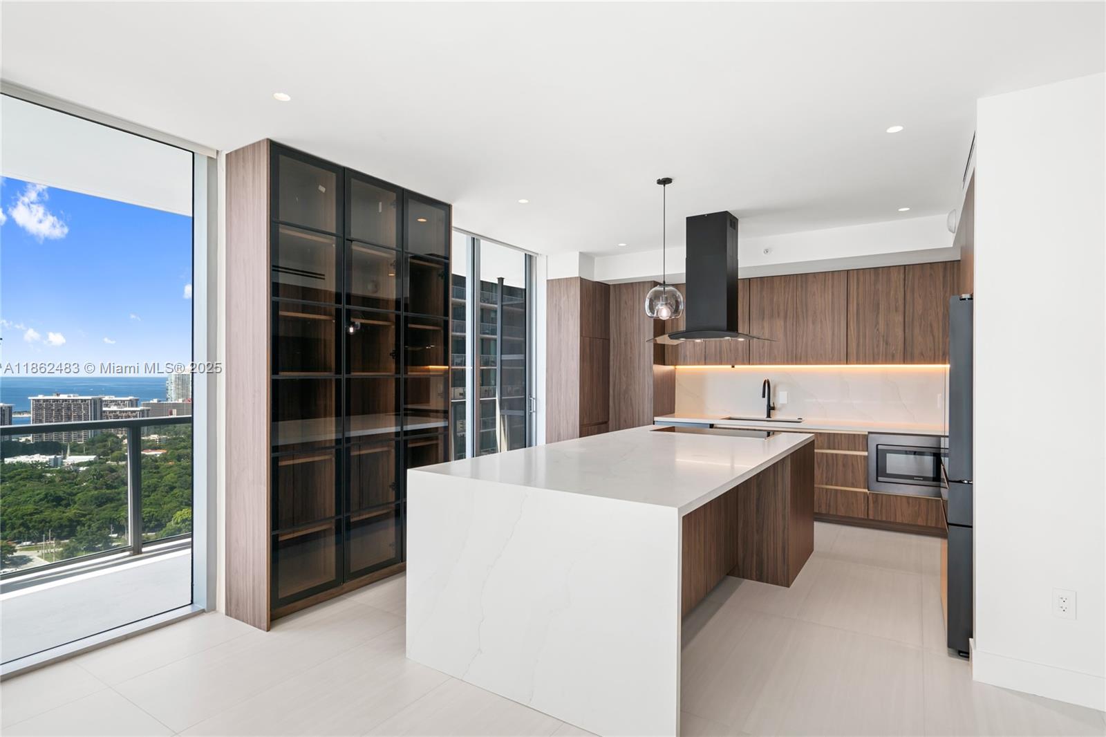 Completely renovated 3BD/3BA corner residence at Axis Brickell North Tower with 1,800+ sq. ft. and a wraparound balcony offering stunning water and city views. Upgrades include all-new appliances, flooring, built-out closets, modern light fixtures, linear A/C vents, and recessed lighting. Each room has balcony access. Comes with 2 assigned tandem covered parking spaces. Luxury amenities: infinity pools, spa, fitness center, kids’ room, business center & BBQ. Walk to Mary Brickell Village, Brickell City Centre, and the Financial District.