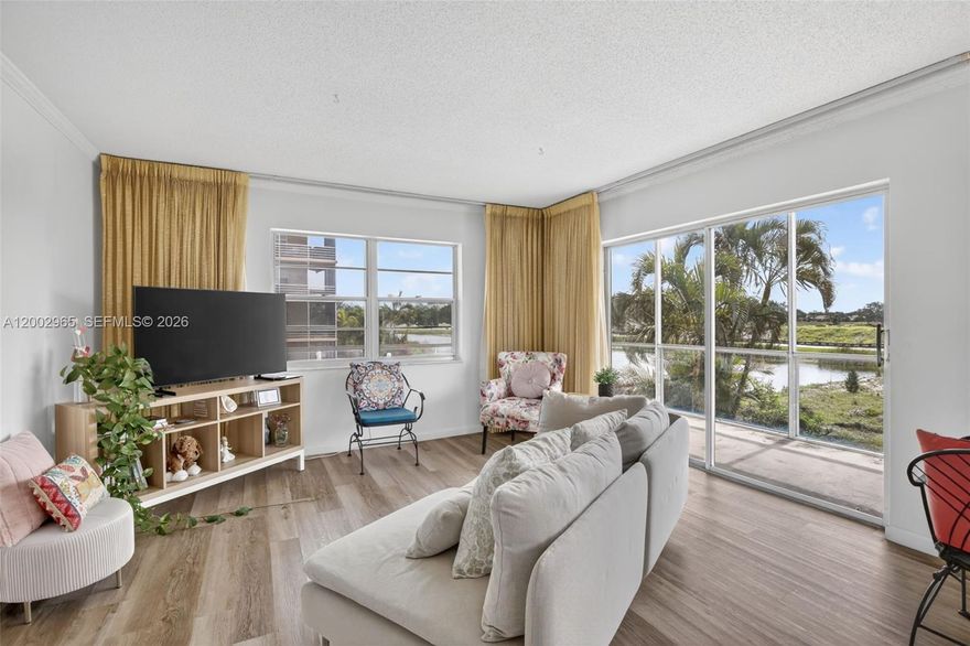 Enjoy year-round sunshine, warm breezes, and the best of South Florida living, where every day feels like a vacation. Wake up to peaceful pool and lake views from this bright 2-bedroom, 2-bath corner condo. With 924 sq ft and natural light from multiple exposures, this home offers comfortable, low-maintenance living in a desirable 55+ community.

The oversized wraparound screened balcony is the standout, creating a true indoor-outdoor space perfect for morning coffee or relaxing evenings overlooking the water & lush landscaping

Inside, you’ll find a clean, well-kept interior with vintage bathrooms, a functional kitchen with durable Formica countertops, and updated vinyl flooring for easy upkeep.

Affordability meets value with this well-maintained building featuring a new roof, new elevators, no assessments, plus a refinished heated pool. Community amenities include clubhouse, tennis, pickleball, shuffleboard, & a convenient shuttle service. 

Location + lifestyle! Convenient to the beach, Sawgrass Mills, Amerant Bank Arena for NHL hockey, concerts, & major events, plus dining, shopping, and highways. Sunrise Civic Center is just 3 miles away with arts, culture, recreation, and events, along with the attached Athletic Club (part of a 100,000+ sq ft facility) offering fitness options like a two-story gym, racquetball courts, & more. 

Residents love the community feel, open spaces, winding sidewalks, grassy areas, & plenty of activities and neighborly gatherings.