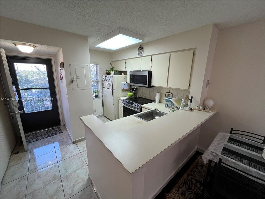 Photo of 2230 N Cypress Bend Dr #309, Pompano Beach, FL 33069 (MLS # A11478433)