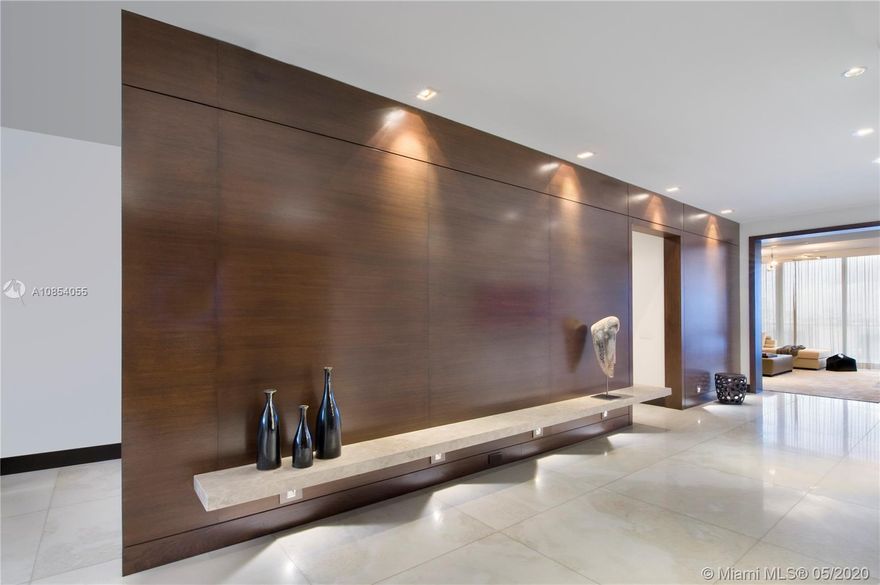 Warm & inviting, this custom designed beautiful 3 bedroom 3 1/2 bath residence is located at the prestigious Apogee on South Beach. This impeccable flow through unit features exceptional sunrise vistas of Fisher Island, and the Atlantic Ocean. Refined elegance includes designer finishes, chefs kitchen, top of the line appliances, fire place, custom millwork, mahogany doors, electric shades and Savant AV system /Lutron lighting. 11 foot wide balconies allow for an indoor/outdoor dining and entertaining experience, featuring an outdoor summer kitchen and gas BBQ. The residence includes a private Air conditioned 2 car garage with storage. Amenities include spa, gym, Bay Front Infinity Pool and concierge.