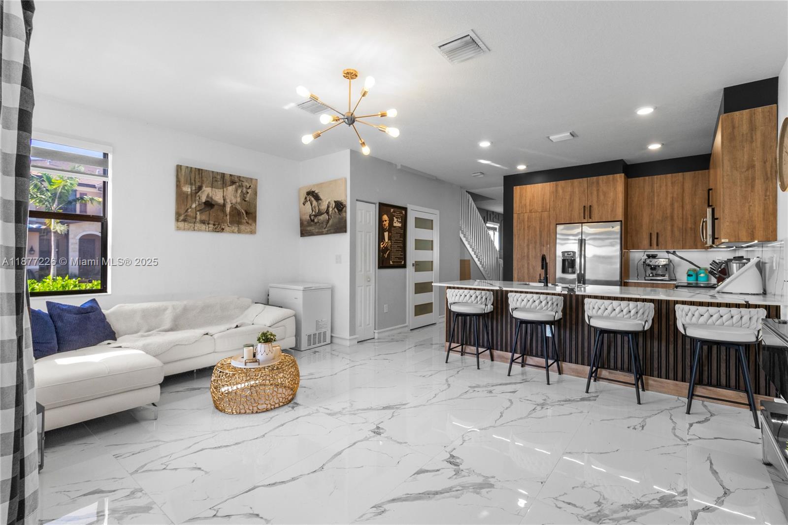 There's no other villa with these upgrades in Hialeah Heights. As a corner unit of 3 beds, 2.5 baths, located in Aquabella, it offers enhanced privacy and natural light. The ground floor and stairs feature a mix of porcelain tile and laminate flooring, while the second floor is entirely porcelain tile. Fully renovated kitchen with a contemporary and elegant design with quartz countertops, quality cabinets. The living room includes built-in closets for extra storage and an electric fireplace that adds warmth and style. European interior doors with magnetic locks, adding a touch of exclusivity. Aquabella offers controlled access, 2 clubhouses with resort-style pool, gym, game room, community lake, kids' park & more.Its location provides quick access to major roads,schools,shops & rstaurnts