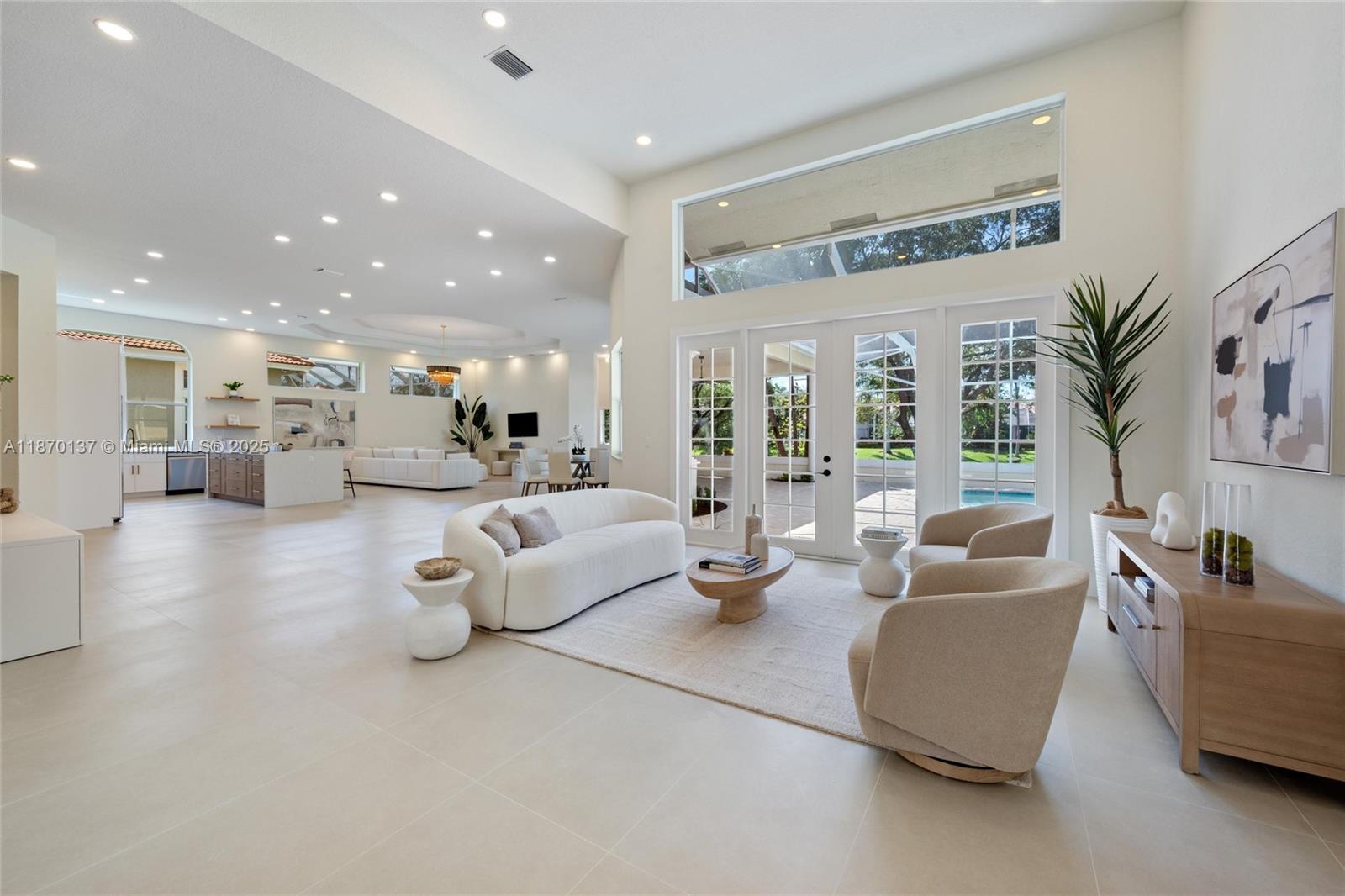 Experience luxury and tranquility in this newly renovated lakefront home in the exclusive gated community of The Isles! Featuring 5 bedrooms and 5 baths, including 4 bedrooms with their own en-suite baths and walk-in closets for ultimate convenience. This residence showcases soaring ceilings, expansive windows, and an open layout filled with natural light & stunning lake views. Enjoy a brand-new kitchen, modern baths, porcelain tile floors, & new appliances. Recent upgrades include updated electrical panels, new garage doors, patio screens, plus a newer roof and A/C. Fully hurricane-protected w/ brand-new accordion shutters. The primary suite impresses with dual walk-ins and a spa-style bath. Step outside to a newly resurfaced pool and beautifully landscaped yard—your private oasis awaits!