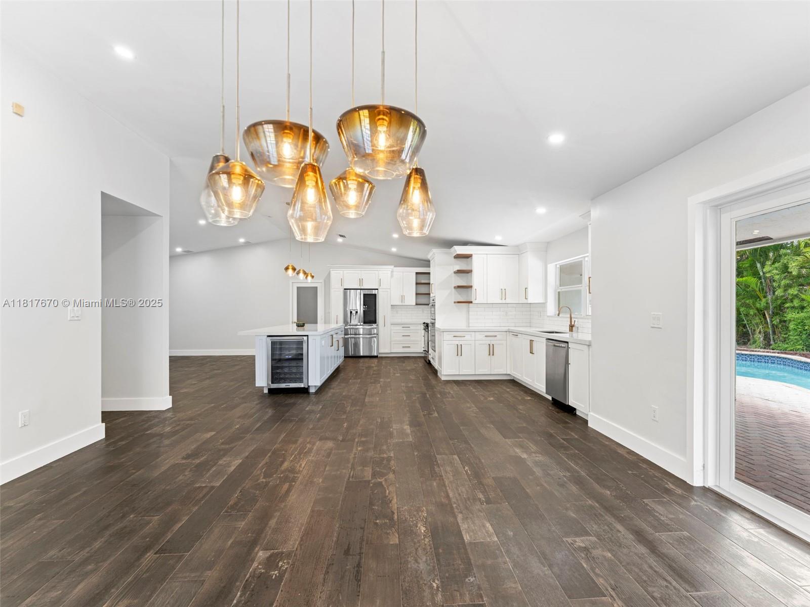 Welcome to this fully remodeled home offers a blend of elegance and comfort featuring 4 bedrooms, 2.5 bathrooms. Enjoy luxury living with open concept, The Stunning chefs kitchen with quartz countertops, modern and beautiful wooden cabinets with several compartments and drawers for organizing. All stainless-steel appliances include top of the line French Insta View Counter Depth smart refrigerator. All impact windows and doors, porcelain "charred wood tile" throughout. Master suite with large walk-in closet/California organizers and modern's large shower. AC units 2016 and 2018. California shutters. Heated pool/spa. New driveway 2020. Don't miss this opportunity to own a modernized gem in a prime location!