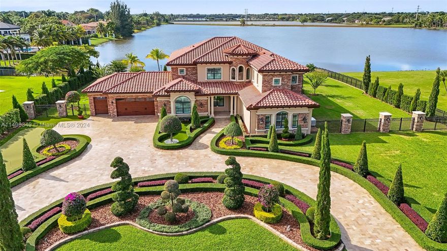 Welcome to Villa Lago - a breathtaking 2-story Mediterranean palace set on a builder’s acre with stunning lakefront views. This estate offers 5BD, home theater, oversized bonus room & 4.5BA. The primary suite is a retreat w/private balcony overlooking the backyard & lake. Master bath offers marble floors, double vanity, & soaking tub. Chef's kitchen w/quartz countertops, Viking appliances, & walk-in wine cellar. Elegant craftsmanship throughout with custom woodwork, crown moldings, & waterproof engineered wood floors. The outdoors is a haven featuring a heated pool with saltwater filtration system & spa, mini-golf driving range, brand new summer kitchen & serene lakefront beach. High-tech Savant system & interior/exterior speakers. A blend of luxury & comfort in every detail!