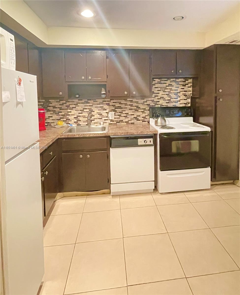 Experience golf course living in this beautifully furnished 1-bedroom, 1.5-bath condo with breathtaking lake views at Palm Aire Country Club. This move-in ready unit is available for an annual lease and includes Cable TV, WiFi, water, sewer, trash removal, pest control, and access to community amenities—pool, BBQ area, tennis, volleyball, basketball courts, and playground. Please note: pets are not permitted. The association requires a minimum credit score of 650 and a $500 refundable security deposit. Enjoy a prime location with easy access to major highways, shopping, dining, and the beach. Offered fully furnished—annual lease only.