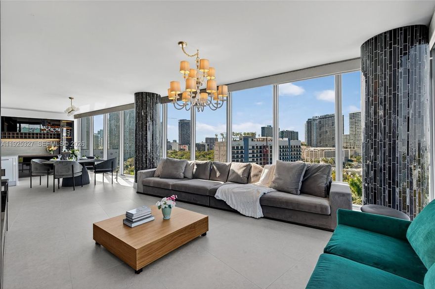 Step into a corner residence wrapped in floor-to-ceiling glass, where the light shifts throughout the day and the city opens up before you. From golden-hour bay reflections to the sparkle of evening skyline views, the living area becomes a quiet pause in the middle of Miami’s energy — a place that feels both calming and inspiring the moment you walk in.

Inside, new floors, custom millwork with integrated LED lighting, automatic blinds, and thoughtful updates create a home that feels intentional and easy to live in. Two true private suites offer flexibility for work, guests, or simply having space to grow, plus a guest powder room that makes hosting feel effortless. The semi-private elevator serving only three units per floor adds a sense of privacy and quiet. Resort-style amenities extend the experience: two pools, jacuzzi + cold plunge, steam/sauna, fitness center, BBQ deck, 24-hour mini market, kids’ playroom, business center, and valet. Two parking spaces (1 assigned + 1 valet) add daily convenience. With 1,449 SF on the 11th floor, the home opens to wide bay + city views that feel different at every hour of the day.

Set in prime Edgewater, minutes from the Airport, Miami Beach, Design District, Midtown, Wynwood, Brickell, and Downtown — this is a place to land and to enjoy Miami in a way that feels personal. A residence that feels connected yet calm, elevated yet effortless. A home that truly reflects the rhythm of the city and the people who live it.