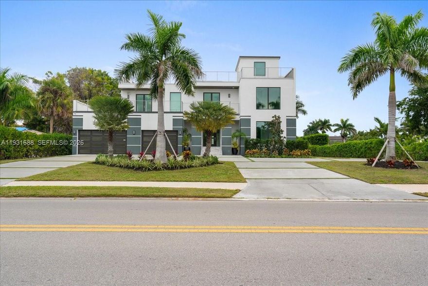 Located across from the water, enjoy waterfront views from entertainers deck! Built in 2023, this exceptional 4-bedroom, 6-bath residence offers the rare opportunity to own a nearly new luxury home in one of Naples’ most sought-after locations—without the premium pricing of waterfront properties. Home features 4 bedrooms and 6 bathrooms with thoughtfully designed living and entertaining spaces throughout. Features include two laundry rooms, a 3-car air-conditioned garage, second-floor wet bar, and multiple indoor-outdoor living areas. The chef’s kitchen is equipped with top-tier appliances, custom cabinetry, and generous workspace, opening seamlessly to the main living areas with soaring ceilings and refined finishes. A private elevator services all levels, including a fully built-out rooftop retreat featuring an outdoor summer kitchen, cabana bath, and water views—ideal for elevated entertaining. Outdoor amenities include a resort-style pool and spa, covered entertaining areas, and lush landscaping. Built with concrete block construction, impact-resistant windows and doors, and premium materials throughout. Ideally located minutes from the Gulf beaches, Venetian Village, and Fifth Avenue South, this move-in-ready home offers luxury living in one of Naples’ most sought-after neighborhood.  With new construction comes peace of mind: modern systems, current building standards, and no renovation delays.