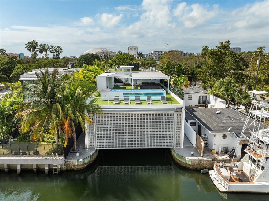 This masterfully rebuilt tri-level modern home located in a quiet treelined family neighborhood offers multiple
levels of luxury & is an oasis in the middle of the city. Truly a boater's dream, it boasts a premium engineered
boathouse to accommodate large vessels, & easy ocean access. A 3rd level private rooftop lounge is a highlight
designed to relax w/pool, summer kitchen, covered seating, & cabana bath. The 4BR/5BA home’s 1st level offers - open living, dining, & kitchen layout plus 1BR/1BA, Spanish tile floors & high ceilings. 2nd level has 3BR’s w/rich hardwood floors – a large principal suite w/spa-style bathroom, walk-in closet & 2 other bedrooms w/ensuite baths. Prime location, minutes to downtown, Wynwood, fine dining & shopping, Brickell City Centre, beaches, expressways.