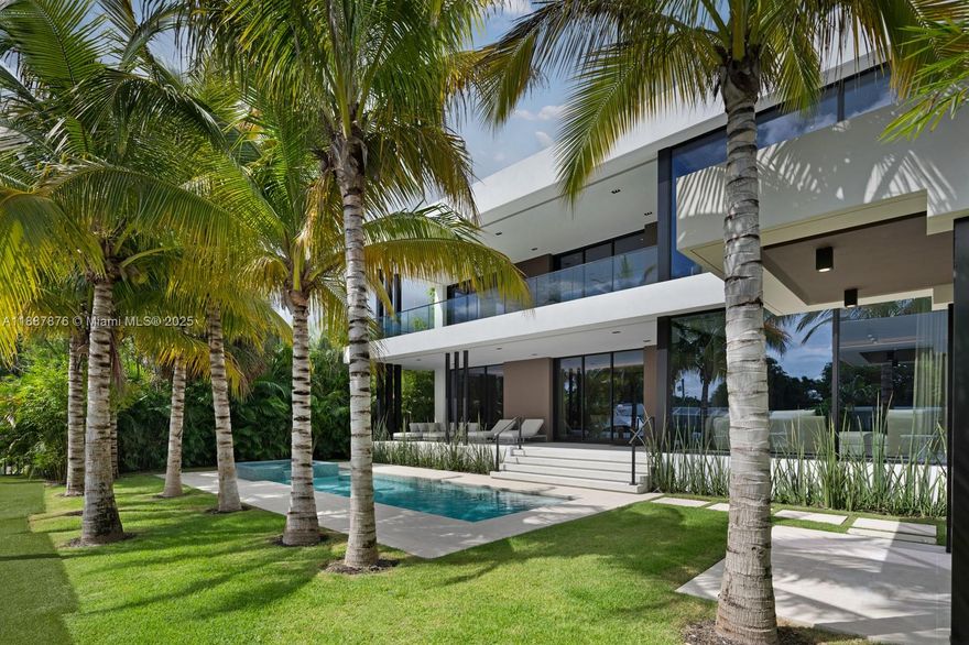 This waterfront estate in gated Keystone Point blends architectural excellence with modern flair. Designed by PRAXIS Architecture + Design and built by Gamma Construction, the never-lived-in residence offers nearly 6,000 sq ft with 6 bedrooms and 5.5 baths. Floor-to-ceiling impact windows bathe the two stories in natural light, highlighting interiors by CB Design with custom closets and spa-like baths. The Italian Mia Cucina kitchen pairs Wolf and Sub-Zero appliances, while a Crestron smart system ensures effortless living. Outdoors, 75 ft of water frontage provides deep-water dockage and direct bay access, alongside a heated saltwater pool, spa, and lush landscaping for privacy. All minutes from Bal Harbour Shops and Miami Country Day School.