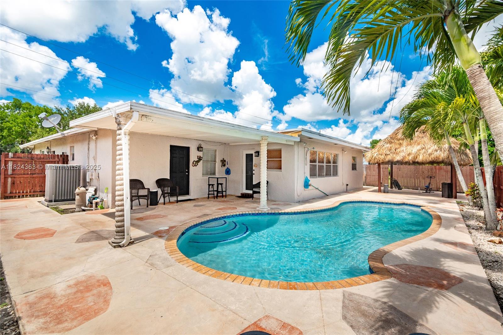 Beautiful 3-bed, 2-bath pool home in highly desirable Pembroke Lakes area. Garage converted into an extra master bedroom with walk-in closet. One of the bedrooms can be an in-law quarters with kitchenette & it also has a private entrance. Home features tile floors, stainless steel appliances, and remodeled bathrooms (2025). Step outside to a private fenced Backyard and enjoy a 2025 renovated tiki hut and lush landscaping. Pool redone in 2018 with LED lights and new pump, perfect for a family BBQ Day or just to relax and refresh. Enjoy peace of mind with a front door ring camera, an alarm system, and 8 cameras (7 outside, 1 inside). New roof (2018), 5-ton A/C (2020), and new gas water heater (2024). This move-in ready home blends comfort, security and style - perfect for Florida living!