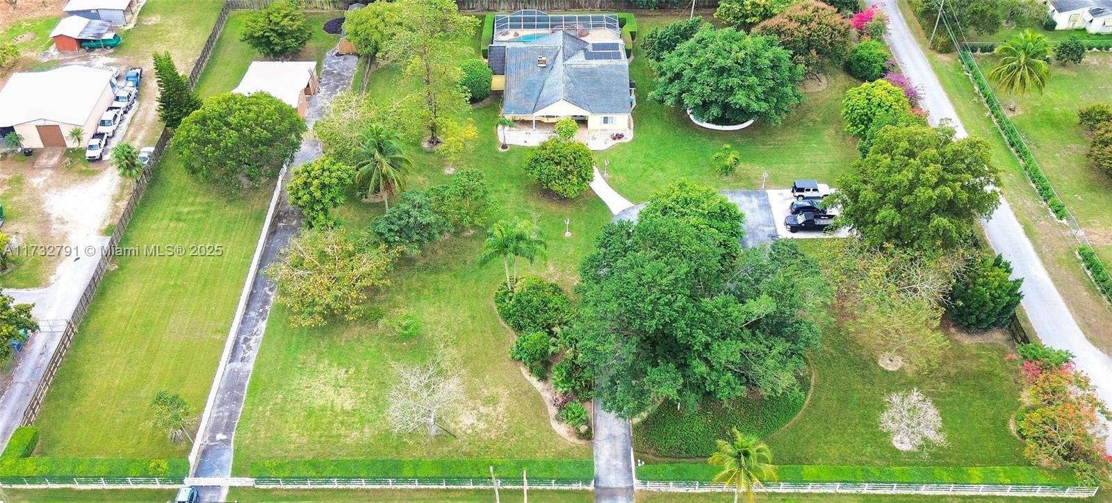Welcome to this beautifully maintained 5-bedroom, 3-bathroom estate, perfectly situated on 2.5 acres of land. The home features high ceilings, impact windows, and updated bathrooms throughout. Outside, you’ll find your very own private oasis—a large, sparkling pool and screened-in patio, perfect for relaxing or entertaining. The property also includes a barn, a large storage room, and is surrounded by exotic and fruit trees that enhance the natural beauty of the landscape. This exceptional property is a rare find—just 30 minutes from the Florida Keys and only minutes from the Florida Turnpike and Homestead Air Force Base.