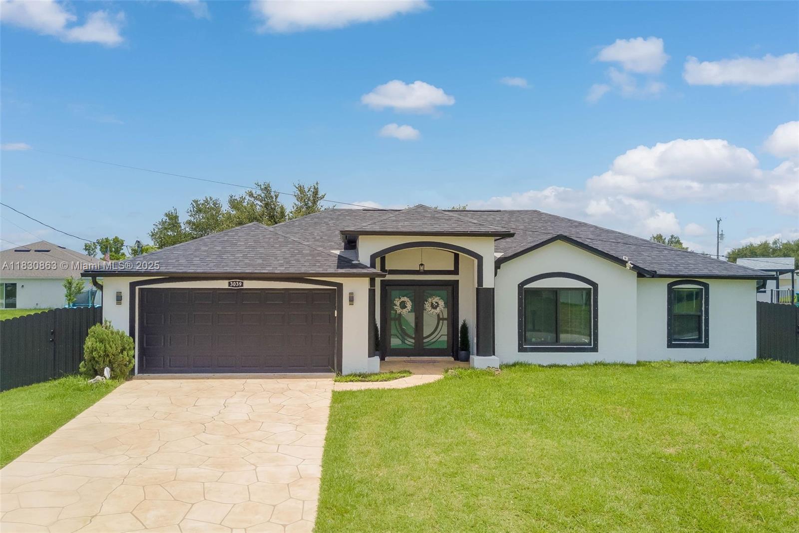 Charming 3-Bedroom, 2-Bath Florida Retreat! This beautiful home features a decorative concrete overlay on the driveway, walkway, and patio, welcoming you to a tropical oasis with litchi nut, mango, banana, cattley guava, and star fruit trees. Inside, enjoy LG stainless steel appliances and a Whirlpool washer and dryer on pedestals. The kitchen and bathrooms showcase matching granite countertops and stylish sinks. Decorative ceiling fans add elegance throughout. The AC system includes approximately 12 years of transferable warranty. Plus, an irrigation system keeps your garden thriving! Located in a NO FLOOD ZONE—no flood insurance required! Relax in the screened patio and spacious closets that offer ample storage. Don’t miss this unique home that captures the Florida vibe!