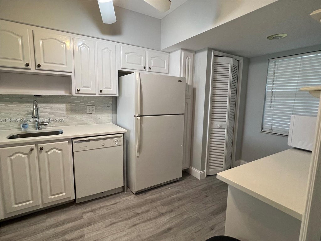 Photo of 2900 N Course Dr #107, Pompano Beach, FL 33069 (MLS # A11465952)