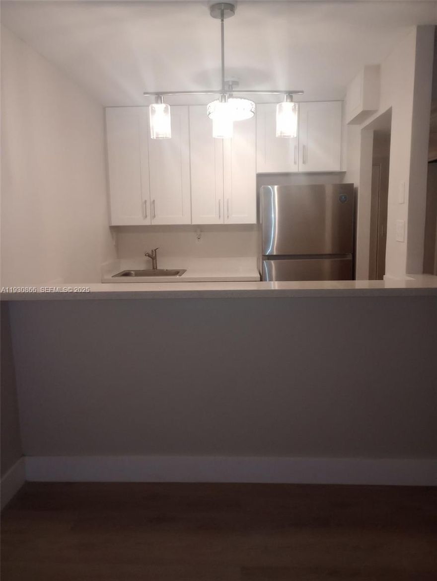 Stylishly renovated, affordable 1-bedroom, 1-bathroom condo in the heart of Hollywood. Enjoy a brand-new kitchen with modern appliances, tile floors throughout, and a spacious layout ideal for comfortable living. The screened balcony overlooks a lush garden, offering a tranquil outdoor retreat. Washer and dryer hookups are conveniently located inside the unit. Located in the well-maintained Hampton Court community with a pool and assigned parking. Just minutes from shops, dining, and major roadways. Great, responsive landlords. Schedule your showing today!