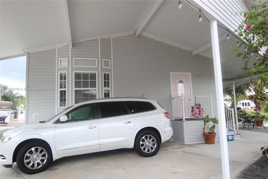 Big O RV Park - 55+ Active Community and very social. This is such a stunning unit. It has crown molding, trey ceilings, rounded corners, solid countertops, very spacious 2 bedroom 1.5 baths, split floor plan. It has a covered area for two golf carts, covered carport for three vehicles, patio looks out over the lake, plenty of storage, man cave has TV, storage cabinet, refrigerator, insulated with A/C. It also has an outdoor kitchen just needs to connect plumbing. There is hurricane shutters. It has its' own boat ramp on the rim canal that goes to Lake Okeechobee.