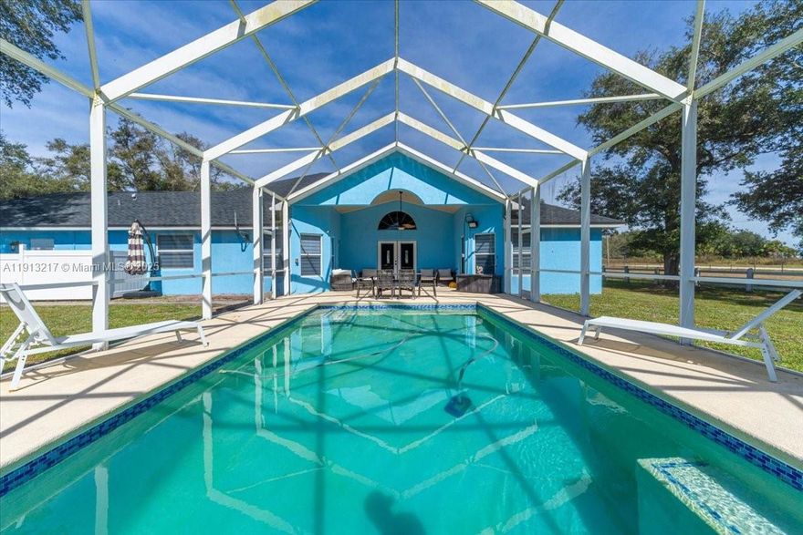 Premium Location! Stunning Remodeled Home on 5+ Acres with Owner Financing Available
Discover this beautifully remodeled 3-bedroom, 2-bath home featuring 2,112 sq. ft. under air (3,326 total). Enjoy the best of Florida living with a screened tropical oasis, complete with a heated saltwater pool and spa, surrounded by lush landscaping and a vaulted front lanai — perfect for relaxing or entertaining. Inside, you’ll find soaring ceilings, a custom kitchen with stainless steel appliances and granite countertops, and a bright open layout that combines comfort and elegance. The property offers ample space for your RV, boat, or recreational toys—all on 5+ peaceful acres that blend quiet country living with proximity to restaurants, shopping, healthcare, and top-rated schools.