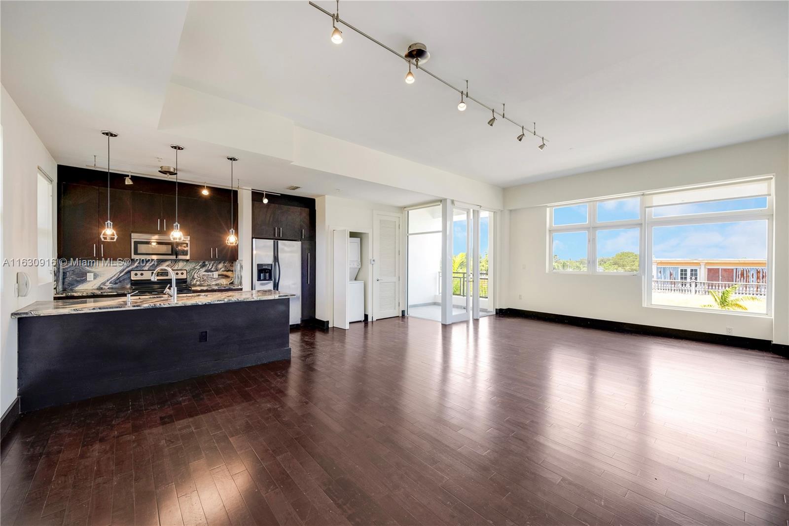 Walk in and be WOWED by the high ceilings, expansive living area and floor-to-ceiling impact windows. This unit’s loft-style design allows you the flexibility and creativity to make the space your own. You’ll find hardwood floors, warm kitchen cabinetry with stone countertops, in-unit washer/dryer, marble bathrooms (1 full, 1 half), large bedroom, small den, and a balcony overlooking vibrant Biscayne Boulevard. 6701 Biscayne is a 3-story elevator building with secured entry and gated parking. Take your pup for a stroll through the MiMo District and enjoy great restaurants and cafes, vintage shops, weekend farmer’s market and parks along the bay.