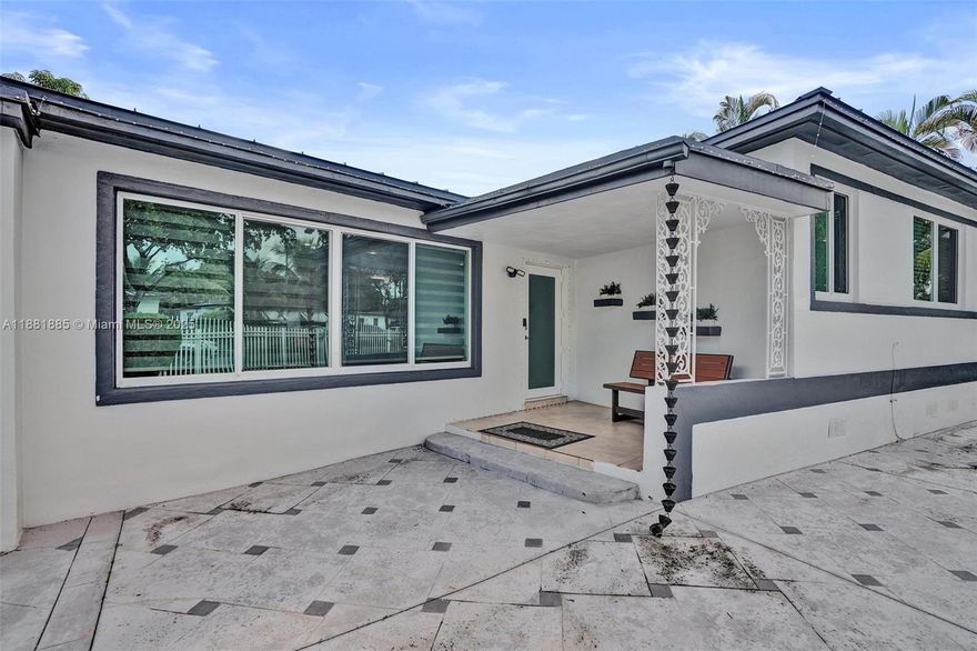 This 3-bed/2-bath home with a gated circular driveway and versatile layout offers endless possibilities. Featuring a split floorplan with spacious living /dining areas, a separate family room, and generous sized bedrooms, The screened-in patio is ideal for entertaining or enjoying quiet evenings outdoors, surrounded by multiple mango trees that add charm and natural beauty. Recent updates include a metal roof that give it that modern feel, hurricane impact windows and doors, offering peace of mind and long-term value. Nestled on a quiet street, yet conveniently close to I-95, this home provides easy access to shopping, dining,  and all that South Florida has to offer—truly combining comfort, convenience, and lifestyle Not to mention a park just blocks away