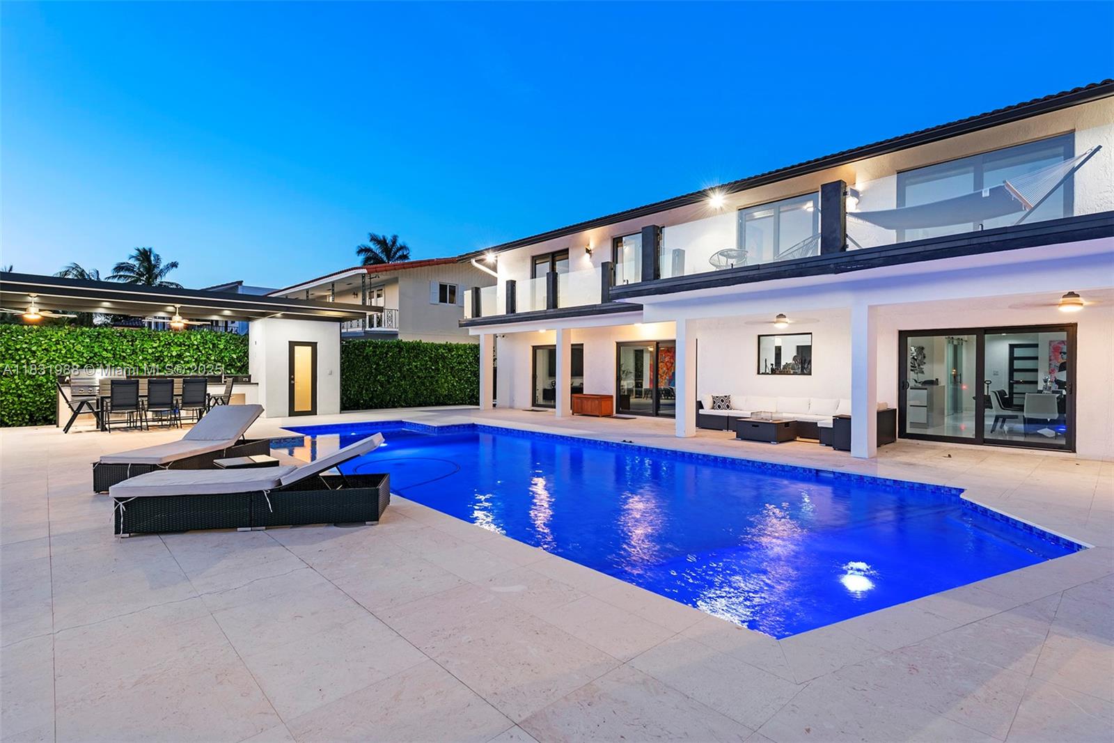 Welcome to this exquisitely 4 beds, 5 baths waterfront. Step inside to an open floor plan with water views from every room. The chef’s kitchen featuring a large island, custom cabinetry, and top-of-the-line Miele appliances. Porcelain/travertine floors add a touch of timeless throughout the home. The primary suite is a private retreat with its own terrace overlooking the pool and canal. The master bath includes dual vanities, double rainfall showers, and a Jacuzzi tub perfect for unwinding in luxury. Step outside to your own backyard paradise. Enjoy a covered outdoor kitchen, heated pool with spa, and 75 ft of waterfront with 24K lb boat lift and Jet Ski dock, just minutes to open bay. Extras: Tesla charger, 2-car garage, San Souci offers 24/7 gated security with on-site police presence.