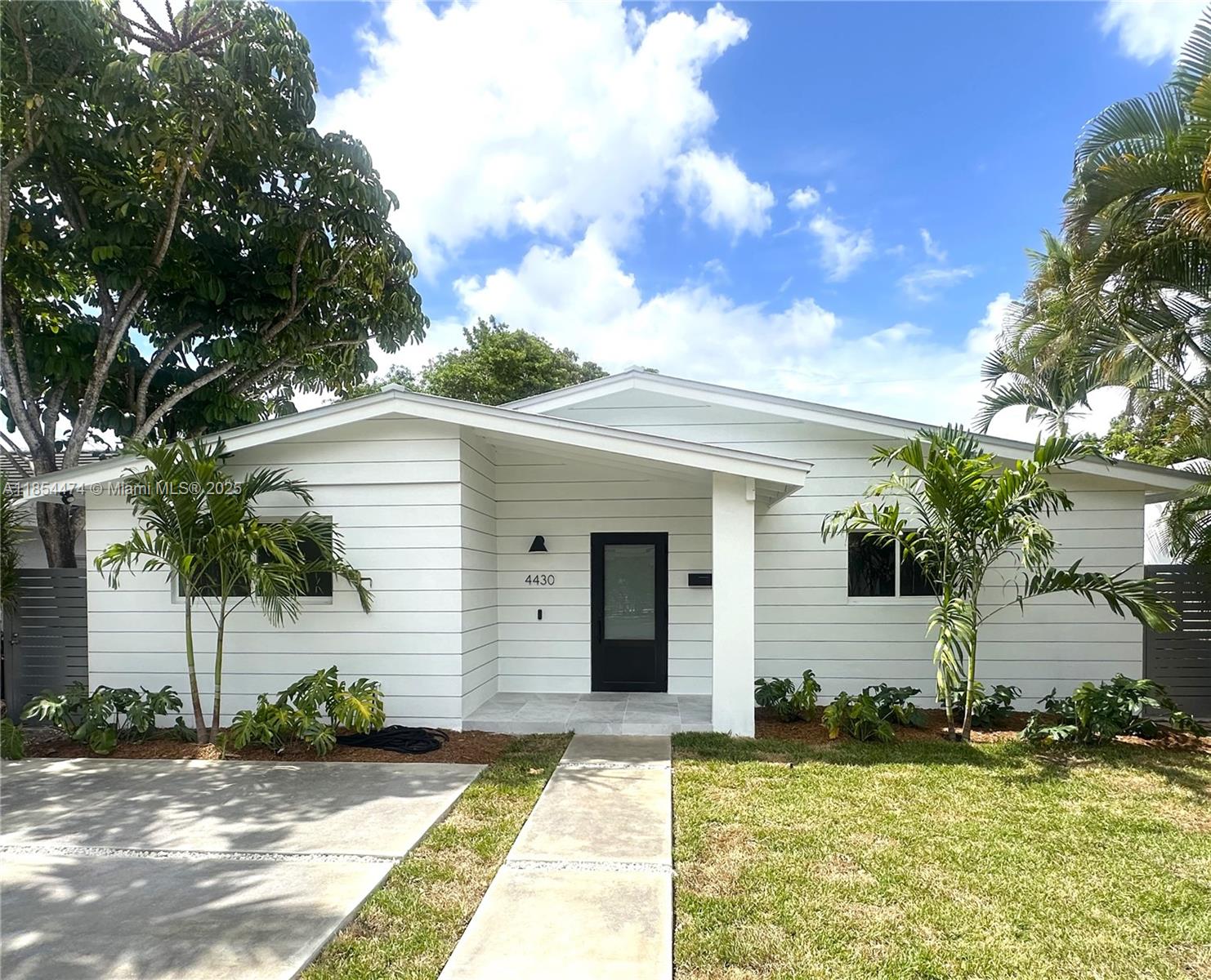 Settle into this charming, newly renovated 4-bed, 3-bath cottage-style pool home in desirable Little Gables. With 1,857 SF of open living, it blends coastal character with modern style and indoor-outdoor entertainment. Wide-plank floors run throughout, and wainscot shiplap adds warmth to the foyer and dining room. The designer kitchen features an eat-in island, quartz counters, high-end appliances, wine cooler, and walk-in pantry. Sunlit kitchen and dining areas open to a covered terrace with marble pavers and ample space to dine or lounge. Enjoy a sparkling pool surrounded by lush landscaping. Impact windows and metal roof (50+ year lifespan) provide energy efficiency and insurance savings. Ideally located minutes from Coral Gables and a short drive to Coconut Grove and Brickell.