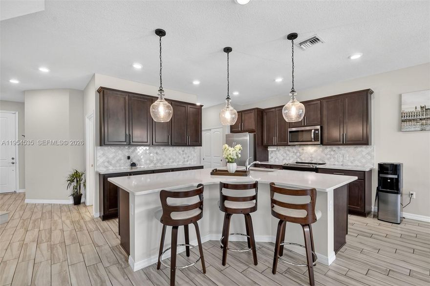 Gorgeous Luxury Townhome in the Highly Sought-After, PET-FRIENDLY, GATED Community of THE FIELDS AT LAKE WORTH by DiVosta Homes. This NEWER-CONSTRUCTION, Two-Story Residence Offers 3 Bedrooms, 2.5 Bathrooms, a 2-CAR GARAGE, EXTENDED DRIVEWAY, and Nearly 1,900 SQ FT of Refined Living Space with IMPACT WINDOWS AND DOORS Throughout.

The Open-Concept Main Level Features Expansive Living and Dining Areas and a Modern Kitchen Highlighted by a LARGE ISLAND IDEAL FOR ENTERTAINING, Sleek Countertops, Stainless Steel Appliances, and Generous Storage. Upstairs, the Primary Suite Is a Private Retreat Offering a WALK-IN CLOSET, FLEX SPACE IDEAL FOR A HOME OFFICE OR SITTING AREA, and a SPA-INSPIRED ENSUITE BATH WITH DUAL SINKS AND WALK-IN SHOWER. Two Well-Appointed Guest Bedrooms, a Full Bath, and a Convenient Laundry Area Complete the Upper Level.

Enjoy a RESORT-INSPIRED LIFESTYLE Just Steps from Exceptional Amenities, Including a Sparkling Pool Area, Elegant Clubhouse, STATE-OF-THE-ART FITNESS CENTER, Tennis and Basketball Courts, Playgrounds, and Beautifully Maintained Green Spaces. Ideally Located Near TOP-RATED SCHOOLS, Parks, Shopping, Dining, MAJOR HIGHWAYS, and AIRPORTS. Schedule Your Private Tour Today and Experience ELEVATED COMMUNITY LIVING at Its Finest.