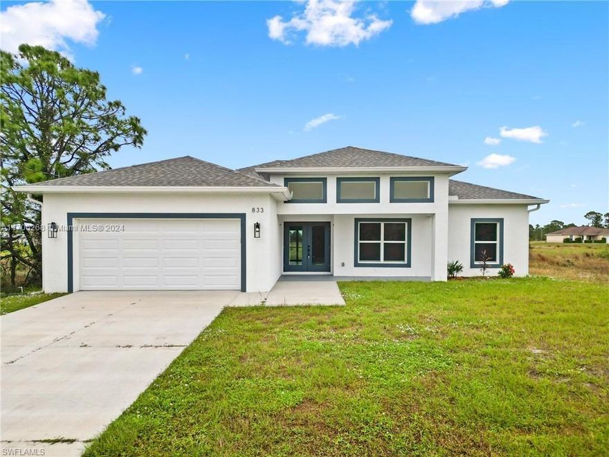 Brand-new ready-to-move-in single-family construction. Open floor plan filled with natural light and high-end finishes, from luxury vinyl floors to impact windows. The kitchen is a chef's delight, featuring a spacious layout with plenty of cabinetry, granite countertops, stainless steel appliances, a large pantry, and a chef’s style sink. Grey cabinets with sleek black accessories. The living room and primary bedroom feature stylish tray ceilings. The primary bathroom offers a tiled walk-in shower with a glass door, while the guest bathroom boasts a beautifully tiled tub-shower combo. With three spacious bedrooms, a den, and ceiling fans throughout. Enjoy Florida’s beautiful weather on the screened-in lanai, perfect for entertaining. A two-car garage completes this exceptional home.