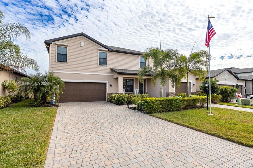 This striking lakefront home in Portico impresses from the moment you walk in and continues to impress daily. Set on one of the community’s most breathtaking long-lake lots, this five-bedroom plus loft, four-and-a-half-bath pool home offers space, flexibility, and stunning water views from sunrise to sunset. Built in 2021, the Sorrento floor plan features an open main level with wood-look tile, crown molding, and a central kitchen with white cabinetry, granite counters, stainless appliances, extended dining cabinetry, and a wine cooler. A full first-floor guest suite with pool access is perfect for guests or multigenerational living. Outside, the oversized lanai with custom pavers overlooks the heated pool and wide water views, with motorized hurricane-rated Kevlar screens. Upstairs, four bedrooms and a flexible loft add space, while upgrades like epoxy garage floors, insulated doors, whole-house water softener, and designer lighting enhance move-in readiness. Located in an X flood zone requiring no flood insurance and equipped with impact-rated windows and shutters, this gated Portico home offers peace of mind and access to a clubhouse, pool, courts, fitness room and play are, all minutes from shopping and dining.