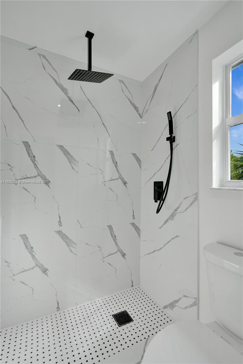 Welcome to this beautifully renovated 4-bedroom, 3-bath home with a 2-car garage & breathtaking golf course views. Enjoy a modern, open-concept layout with soaring ceilings & an abundance of natural light.The kitchen is a chef’s dream, boasting quartz countertops, new stainless steel appliances & contemporary tile flooring. All bathrooms have been remodeled. The spacious master suite includes a large walk-in closet. Every detail has been carefully considered, from the fresh interior & exterior paint to the NEW roof installed in 2022.Energy-efficient solar panels help reduce your monthly FPL bill. NO HOA! Located near the prestigious Woodmont Country Club, where optional membership includes access to golf, a resort-style pool, gym, tennis courts, pickleball, restaurant, & bar.TURN-KEY ready