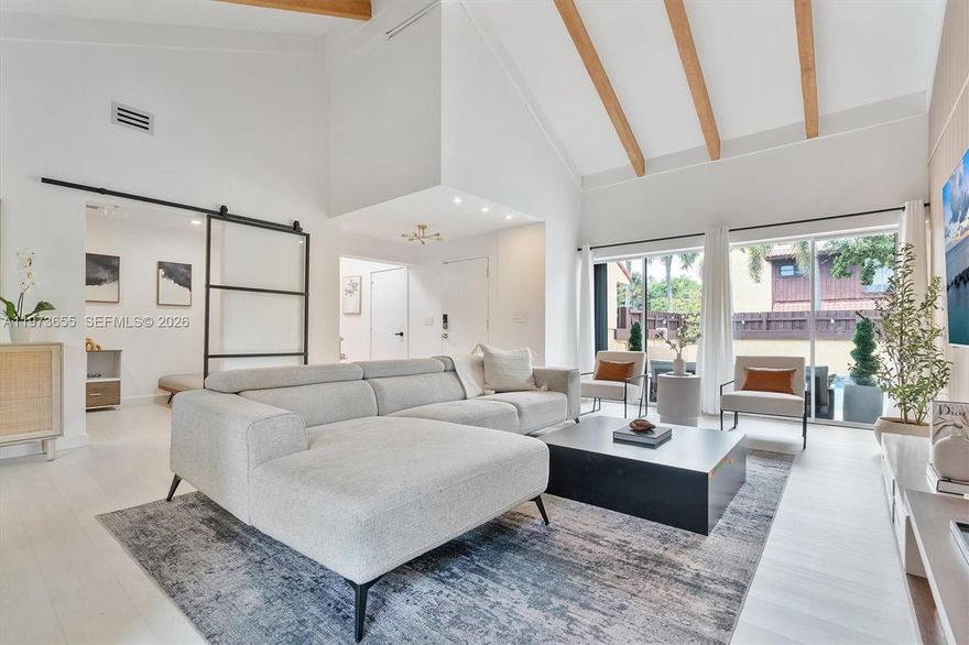 Welcome to this completely redesigned 2-bedroom, 2-bathroom home with a flex room perfect for a den, office, or guest space. The open-concept kitchen is the heart of the home, featuring a quartzite waterfall island and 2025 Samsung Bespoke smart appliances, ideal for cooking or entertaining. Smooth skim-coated walls and ceilings, fresh white paint, luxury vinyl flooring, and square hi-hat lighting create a bright, modern atmosphere throughout. Exposed wood beams have been sanded to their natural color, adding warmth and character, while decorative slat wall panels, custom wallpaper, updated air vents, modern fixtures, and LE Grand light switches elevate the details. The garage is already plumbed for an additional bedroom and bathroom, with plans available, offering a rare opportunity to expand living space. Just outside you'll find a heated saltwater courtyard pool with a papered deck, perfect for private, year-round enjoyment. Major updates include a 2024 flat roof, 2018 HVAC, and updated water heater. Maintenance includes paint, WiFi, cable, and front yard care. A turnkey home with luxury finishes, thoughtful upgrades, and room to grow. This property will not last.