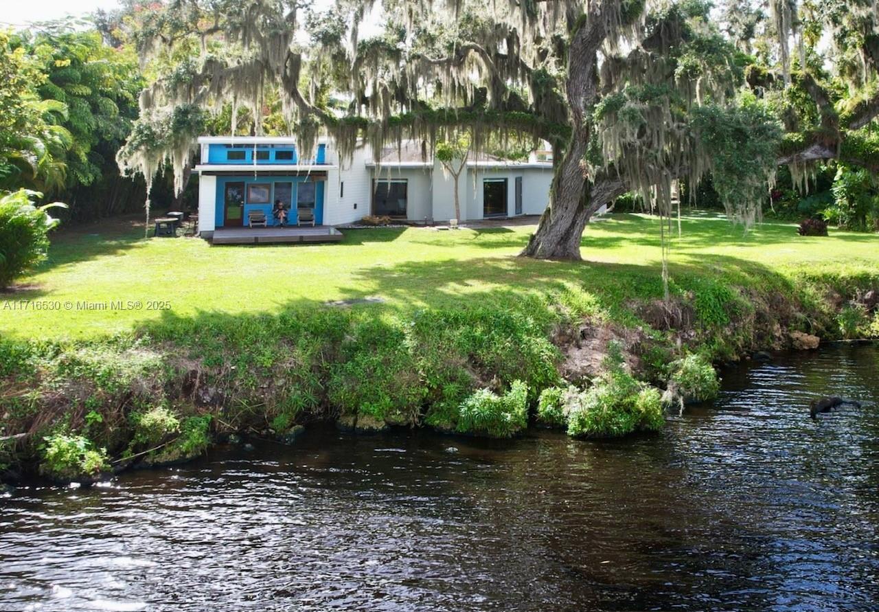 THIS UNIQUE BOAT-INSPIRED HOME ON PIE-SHAPED .65 ACRE, FANNING OUT TO 135' ON THE STUNNING CALOOSAHATCHEE RIVER, PART ON THE INTRACOASTAL WATERWAY! Concrete block home features a 2017 roof and unique features such as the statement umbrella-style ceiling in the open living area which also features floor to ceiling glass panels overlooking breathtaking views! The master suite with its’ expansive skylight ceiling for stargazing with privacy closure panels and second bedroom with built-ins. Third bedroom is full-size efficiency apartment with living area, kitchenette, bath, private entry and wood deck. Outdoor lovers will enjoy the front entry courtyard along with multiple outdoor patios and walkways plus an attached tree house!