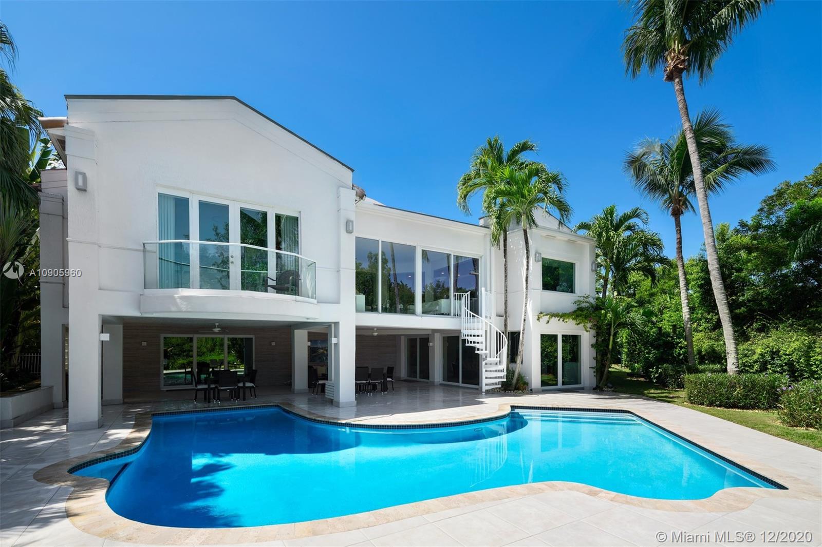 Live a lifestyle of luxury and effortless living at this completely remodeled waterfront modern estate in Islands of Cocoplum! Walk through a dramatic entrance door into a gorgeous light-filled expansive foyer with double volume ceilings. This is a chic, elegant, yet relaxing home. The first floor has all essential living areas including 5 beds/5.5 baths, formal living & dining, informal dining & family room, gorgeous MiaCucina kitchen with Sub-Zero & Wolf appliances, white quartz countertops, separate service quarters. White Porcelanosa tiles, impact windows & doors, incredible water views. Downstairs has kitchen/dining area, large multi-purpose room, office/bedroom, full bath, storage room, expansive covered porch & patio with white porcelain pavers. Ideal
space during a quarantine!