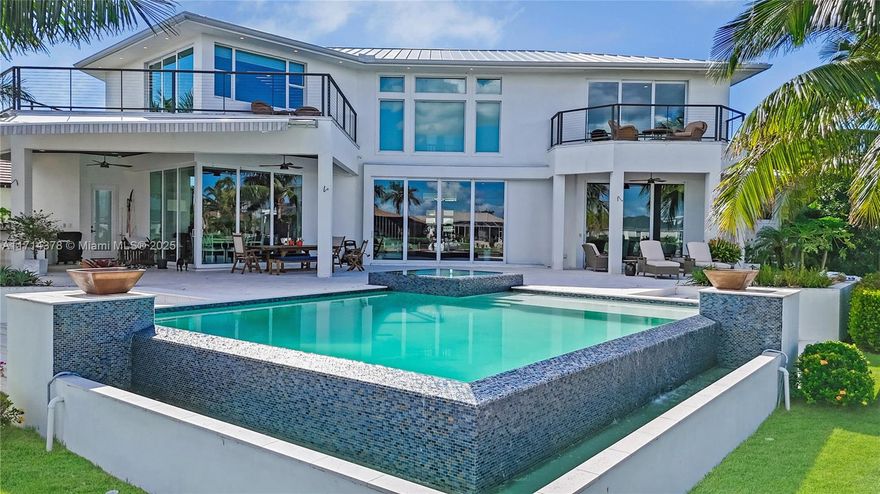 Discover this 2018 custom-built luxury estate in SW Cape Coral, ideally positioned at a private cul-de-sac with 192 ft Gulf-access water frontage and stunning canal views. This modern home boasts 4 Beds + an office, 4.5 Baths, modern finishes, and Savant smart home tech, it features impact windows, abundant natural light, and serene water views. The gourmet kitchen includes Wolf and Sub-Zero appliances, quartz countertops, a bar, and a butler's pantry. The first-floor oversized primary suite offers a boutique closet and a spa-like bathroom. Upstairs, find a loft, a second primary bedroom, and two additional bedrooms with private balconies. Outdoors, enjoy the infinity-heated pool, 2024 tiki hut, summer kitchen, and fenced patio. A rare Gulf-access gem! Schedule a showing today!
