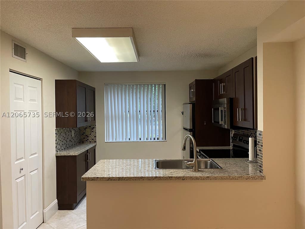 Photo of 10101 W Sunrise Blvd #106, Plantation, FL 33322 (MLS # A12065735)