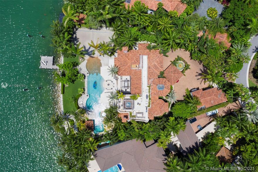 The property sits on a huge double pie-shaped lot with bay views & views of Star Island. A private playground with endless amenities. From the temperature controlled wine cellar, to the rooftop & groundfloor jacuzzis. As you enter, you’re greeted by its 35-FT foyer with its interior courtyard & inside, you’ll find a fully equipped gym, a cinema, along with Crestron smart operating systems. Step out to the tropical oasis with a resort style 120-FT long pool, Jacuzzi, a volleyball court, a fire pit, a waterfall slide, cabana bath, pool built-in bar stools, BBQ and an outdoor dining area with a custom built retractable awning that encloses the entire space. This property offers a rare dock capable of accommodating large yachts.