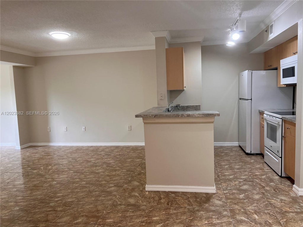 Photo of 2496 Centergate Dr #205, Miramar, FL 33025 (MLS # A12023382)